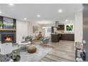 Open-concept living space with a fireplace, modern decor, and seamless flow to the kitchen and dining area at 3288 Tarragon Dr, Decatur, GA 30034