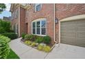 Brick home featuring a landscaped front, concrete walkway, and a convenient two-car garage at 5066 Healey Dr, Smyrna, GA 30082