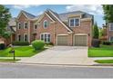 Traditional brick two-story home with a well-maintained lawn and two-car garage at 5066 Healey Dr, Smyrna, GA 30082