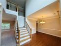 Bright foyer with hardwood floors, staircase, and high ceilings leading to the dining area at 1652 Park Hollow Ln, Lawrenceville, GA 30043
