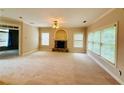 Spacious living room with fireplace and large windows, providing ample natural light at 1652 Park Hollow Ln, Lawrenceville, GA 30043