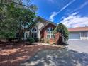 Charming home featuring brick and siding exterior, beautiful landscaping, and large windows, offering curb appeal at 3836 Vineyards Lake Nw Cir # U17, Kennesaw, GA 30144