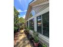 Siding of home featuring large windows, and potted plants, ideal for enjoying natural light and greenery at 3836 Vineyards Lake Nw Cir # U17, Kennesaw, GA 30144