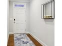 Bright entryway with hardwood floors, a stylish rug, and modern decor at 8215 Harlond Way, Suwanee, GA 30024