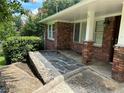 Lovely brick home exterior featuring a covered front entrance and stone walkway at 2711 Fairlane Dr, Atlanta, GA 30340
