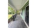 Covered porch with stained wood flooring at 49 Patty Dr, Dallas, GA 30157
