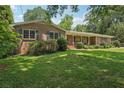 Well-maintained brick house with lush landscaping, inviting porch and a long driveway at 1501 Memory Se Ln, Smyrna, GA 30080