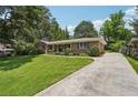 Charming brick home featuring a well-manicured lawn and inviting front porch at 1501 Memory Se Ln, Smyrna, GA 30080