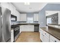 Modern kitchen featuring white cabinets, stainless steel appliances, and ample counter space for meal preparation at 5013 Centennial Commons Nw Dr, Acworth, GA 30102
