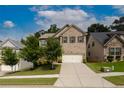 Beautiful two-story brick house with lush landscaping and a two-car garage at 565 Lance View Ln, Lawrenceville, GA 30045