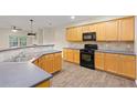 Well-equipped kitchen with ample counter space, wood cabinets, and a gas range at 3300 Suttles Sw Dr, Atlanta, GA 30331