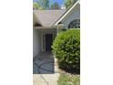 Elegant front door with side windows, and a large bush providing curb appeal at 3510 Hog Mountain Rd, Dacula, GA 30019