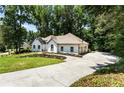 Side view of a white brick home showing a three car garage and driveway at 251 Waller Nw Cir, Marietta, GA 30064