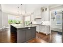 Bright kitchen features a central island with granite countertops, stainless appliances, and hardwood floors at 2638 Clairmont Rd, Atlanta, GA 30329