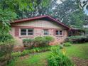 Well-maintained brick home with traditional shutters and a lush green lawn at 4714 Darlene Way, Tucker, GA 30084