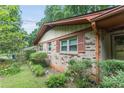 Charming brick house with shutters, lush landscaping, and mature trees at 4714 Darlene Way, Tucker, GA 30084