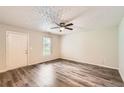 Bright and welcoming living room with stylish flooring and a door leading to the exterior at 7127 Greenway Sw Cv, Covington, GA 30014