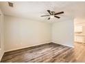 Bright living room features stylish flooring, a ceiling fan, and a view into the kitchen at 7127 Greenway Sw Cv, Covington, GA 30014