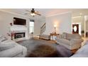 Cozy living room features a fireplace, hardwood floors, neutral walls and a staircase at 2540 Ridgehurst Dr, Buford, GA 30518