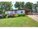 Charming home with well-kept lawn, pretty plants, and a convenient carport at 2646 Rockcliff Road Se, Atlanta, GA 30316