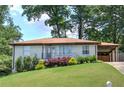 Single-story home with fresh landscaping and a convenient covered carport at 2646 Rockcliff Road Se, Atlanta, GA 30316