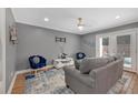 Comfortable living room with a modern ceiling fan, stylish furniture, and hardwood floors at 764 Patterns Sw Dr, Mableton, GA 30126