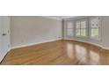 Bright bedroom featuring hardwood floors and ample natural light from large windows at 1324 Concord Sw Cir, Lilburn, GA 30047