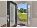 Elegant front door with decorative glass panels offering a glimpse of the well-kept lawn at 1324 Concord Sw Cir, Lilburn, GA 30047