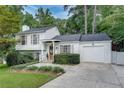 Attractive two-story home featuring an attached garage, complemented by lush landscaping and a welcoming walkway at 2716 Meadow Ridge Nw Dr, Duluth, GA 30096