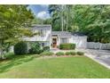 Charming two-story home with white siding, an attached garage, a manicured lawn and mature landscaping at 2716 Meadow Ridge Nw Dr, Duluth, GA 30096