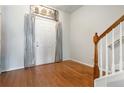 Inviting entryway with hardwood floors and charming decor leading to the staircase at 5351 Paramount View Way, Sugar Hill, GA 30518