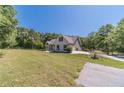 Exterior view of house with a green lawn and an attached garage at 664 Johnson Rd, Oxford, GA 30054