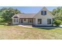 Charming home featuring a white painted brick exterior, black shutters, and a lovely front lawn at 664 Johnson Rd, Oxford, GA 30054
