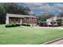 Charming two-story brick home featuring a two-car garage and covered parking area, beautifully landscaped front yard at 125 Pebble Beach Ct, Atlanta, GA 30349