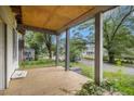 Covered porch needing renovation with a wood deck and exposed plywood ceiling at 1406 Allene Sw Ave, Atlanta, GA 30310