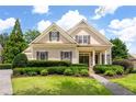 Charming home featuring a well-manicured lawn and lovely, trimmed greenery and sidewalk to the front door at 6186 Talmadge Nw Run, Acworth, GA 30101