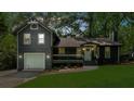 Charming home with a well-manicured lawn, attached garage and a cozy front porch at 1690 Eaglecreek Trl, Cumming, GA 30041