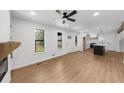 Bright and airy living room features a fireplace, modern ceiling fan and new flooring at 1690 Eaglecreek Trl, Cumming, GA 30041