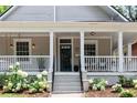 Inviting front porch with classic columns, complemented by lush hydrangeas and a welcoming entrance at 343 Josephine Ne St, Atlanta, GA 30307