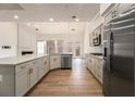 Modern kitchen featuring stainless steel appliances, granite countertops, and ample cabinet space at 401 Wellwood Way, Roswell, GA 30075