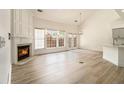 Bright living room with hardwood floors, fireplace, and large windows with natural light at 401 Wellwood Way, Roswell, GA 30075