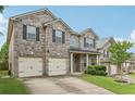 Well-maintained brick home featuring a two-car garage, green lawn, and landscaped front yard at 931 Sublime Trl, Canton, GA 30114