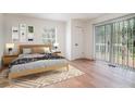 Bright bedroom with a sliding glass door and a natural wood frame bed with a patterned blanket at 1917 Connally Dr, Atlanta, GA 30344