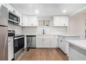 Modern kitchen featuring white cabinets, stainless steel appliances, subway tile backsplash, and quartz countertops at 1917 Connally Dr, Atlanta, GA 30344