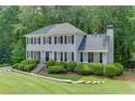 Charming two-story home with manicured lawn and beautiful, mature trees in the background at 2903 Brookshire Way, Duluth, GA 30096