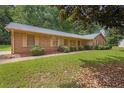 Spacious home featuring a well-manicured lawn, attractive landscaping, and a side entry garage at 326 Acaro Ct, Ellenwood, GA 30294