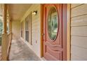 Close-up of a traditional front door featuring decorative glass, sidelights, and a covered porch at 326 Acaro Ct, Ellenwood, GA 30294