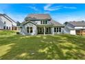 Large backyard featuring a covered patio and ample green space, perfect for outdoor activities and relaxation at 1114 Low Water Crossing Nw, Acworth, GA 30101