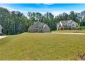Beautiful two-story home with brick, stone accents, two-car garage and a large lawn surrounded by mature trees at 1114 Low Water Crossing Nw, Acworth, GA 30101