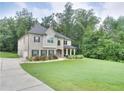 Traditional two-story home with manicured lawn, landscaping and a long driveway at 116 Chorley Run, Ellenwood, GA 30294